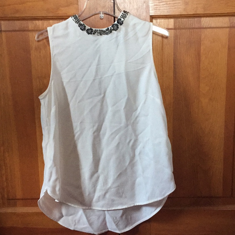 Sleeves off white tank with dark silver detail